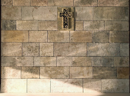 Kronos limestone cladding on the back wall of a master bedroom headboard
